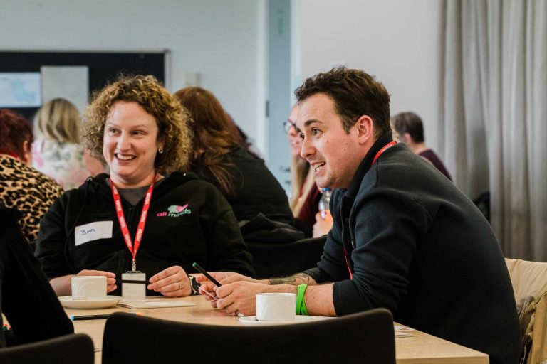 Two people at a table chatting