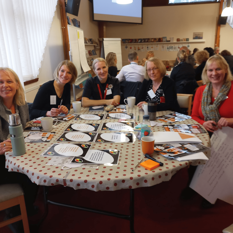 A group of people around a table.
