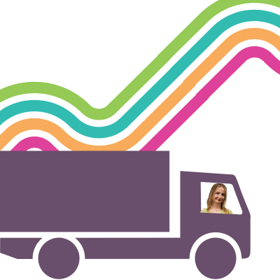 A purple lorry sits in front of a backdrop of a bendy road made up of four different coloured lines. A woman is seen in the window of the drivers seat of the lorry.